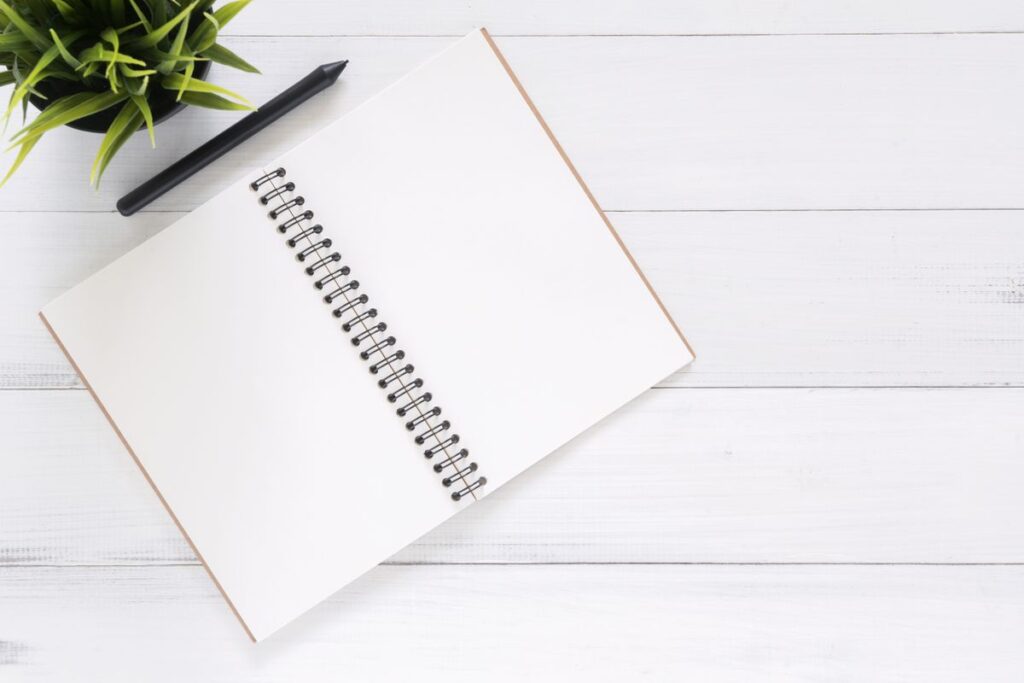 Open notebook and pen for project planning